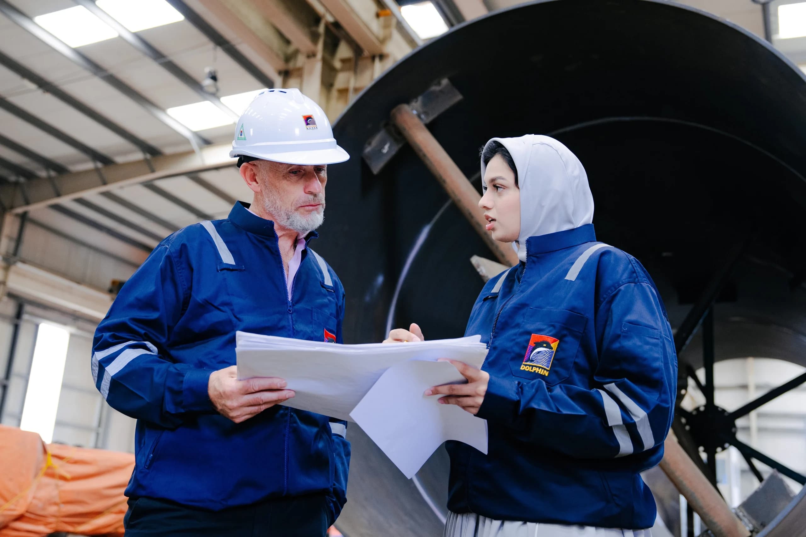 Dolphin Group engineers reviewing project drawings together on the shop floor