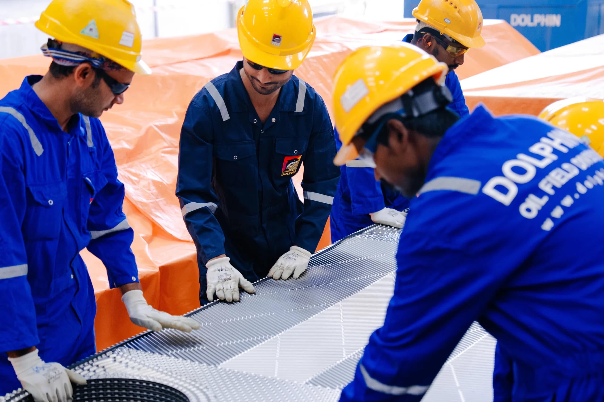 Dolphin Group technicians handling a heat exchanger plate pack